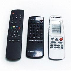 three remote controls on a white surface designed with membrane keyboards.